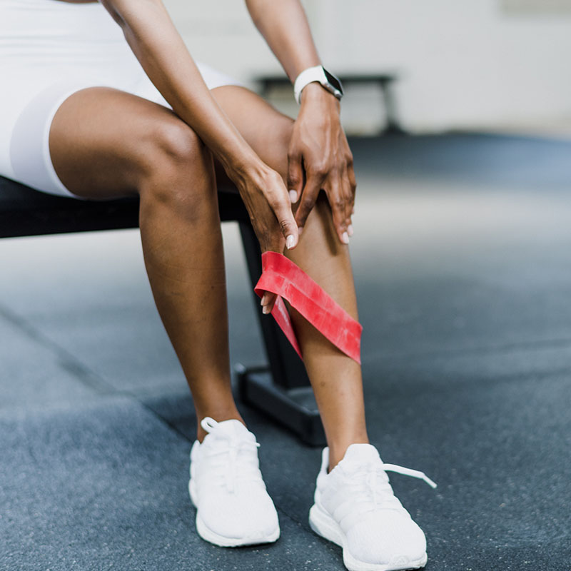 Woman holding her knee, representing musculoskeletal physiotherapy at Movement Perfected Physiotherapy.